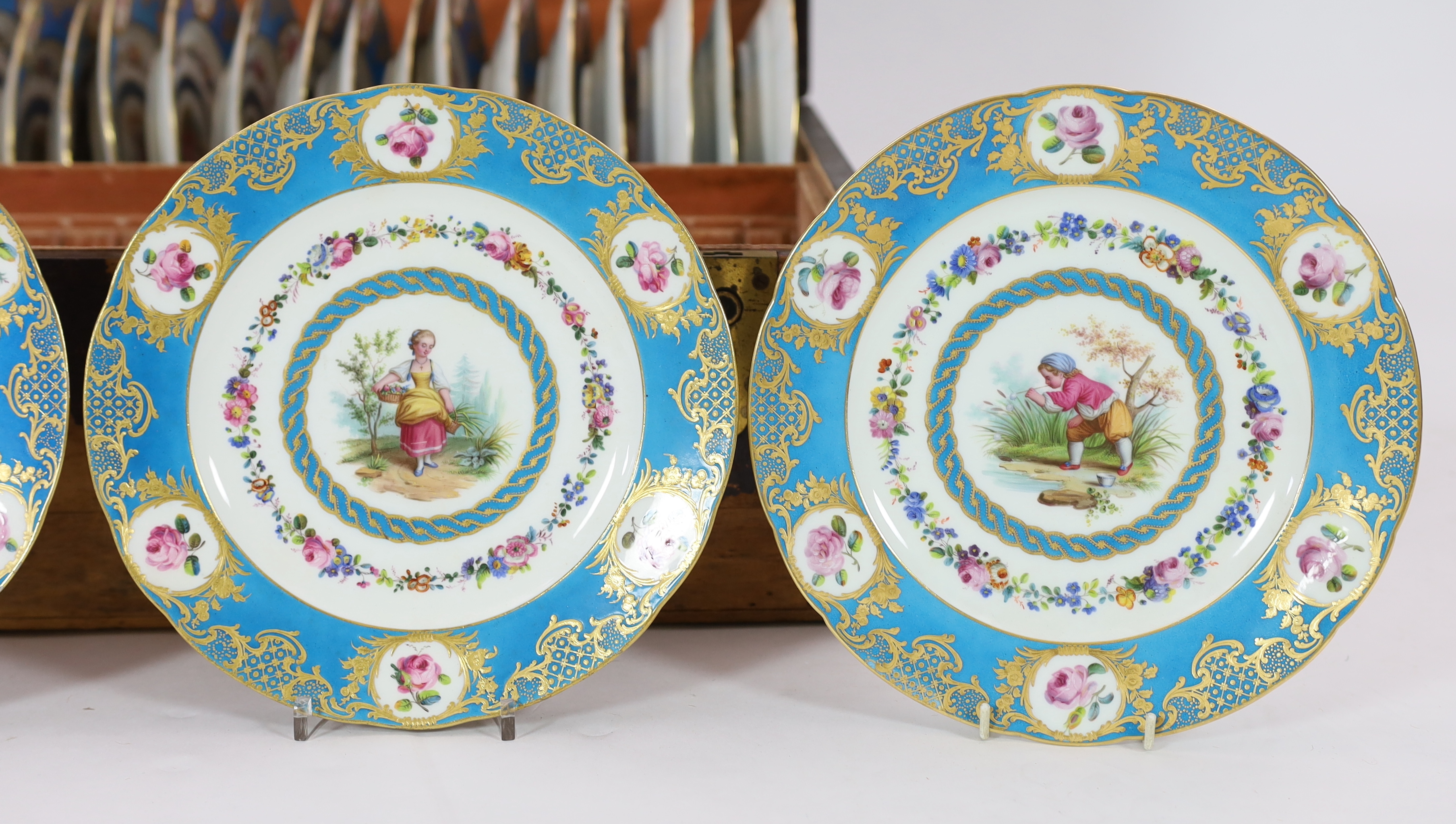 A cased set of twenty four Sevres style cabinet plates, 19th century